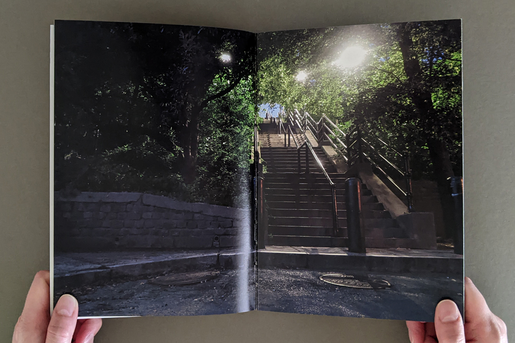 Pictures From the Outside, inside spread: full-bleed spread with a photo of an outdoor staircase, taken at night